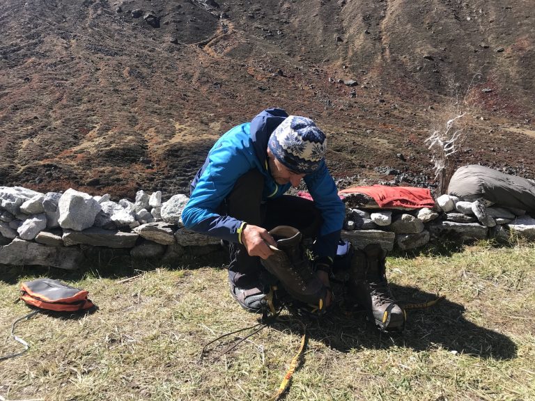 Climber checking gear before the ascent
