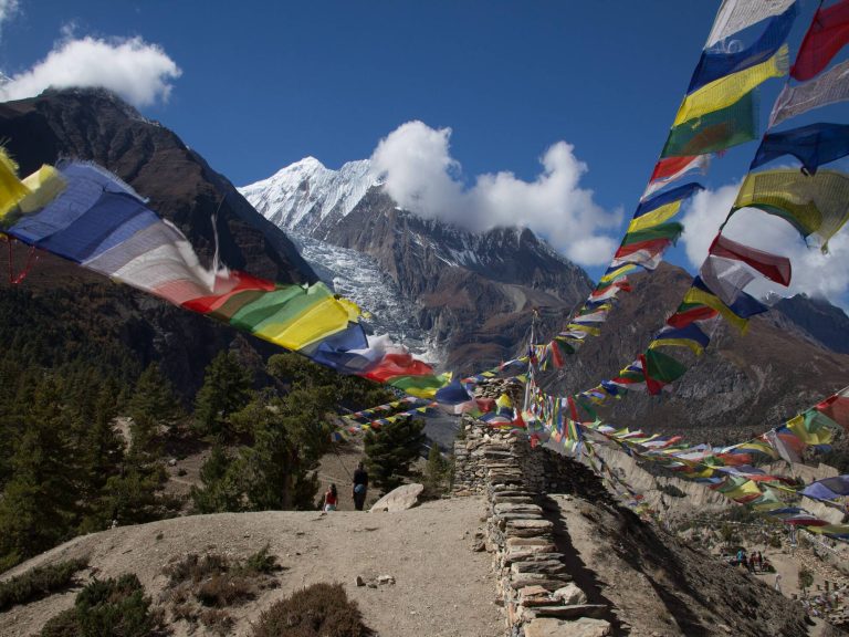 Manang Village with Annapurna III and Gangapurna behind prayer flags